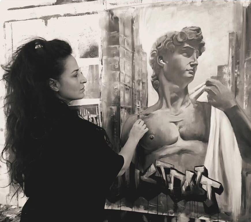 Galit Cohen in her studio, beside a painting of David